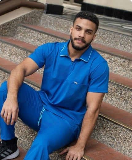 Man wearing a blue outfit sitting on steps